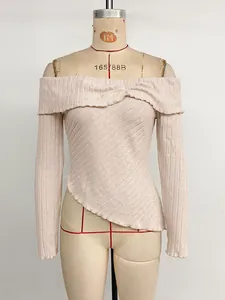 Detail of off-shoulder ribbed knit long sleeve top with an asymmetrical hem in pink