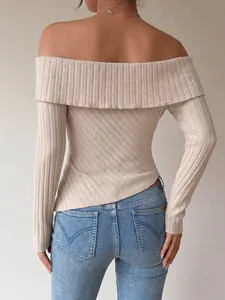 Back view of beige off-the-shoulder ribbed knit long sleeve top with irregular hem