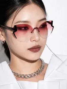 Close-up of woman wearing retro cat-eye sunglasses with red gradient lenses