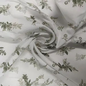 Macro detail shot of soft French style floral print fabric with vintage green flowers