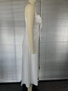 Side view of elegant white French style spaghetti strap maxi dress on mannequin