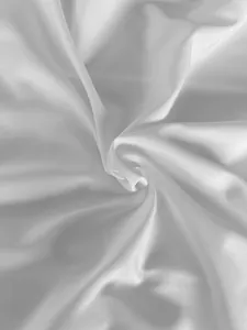 Close-up macro view showing the luxurious white satin fabric texture of the dress