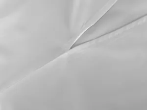 Macro view showing fine stitching and slit detail of white French style dress