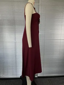 Side view of an elegant burgundy French style slip maxi dress with a slit on a mannequin