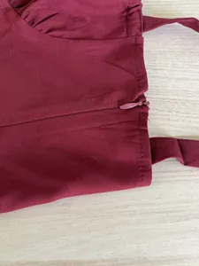Close-up detail of invisible side zipper on wine red French style sundress fabric