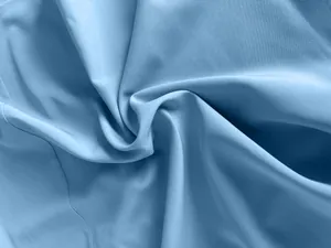 Macro detail of soft light blue fabric texture for French style suspender dress