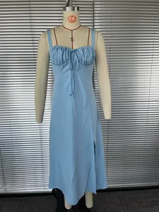 Detailed view of a light blue French-style spaghetti strap dress with a ruched tie bust.