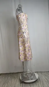 Side profile view of a French style floral slip midi dress featuring a side slit.