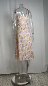 Detailed back view of a French style floral print spaghetti strap midi dress with side slit
