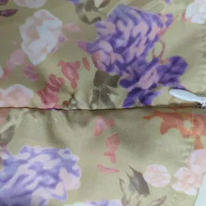 Macro detail of French style floral print dress featuring a white invisible zipper