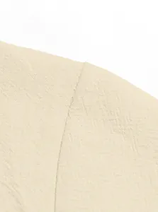 Macro detail of natural beige cotton linen fabric and stitching on a casual men's shirt