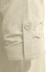 Detail view of men's linen shirt sleeve with button tab and visible fabric texture