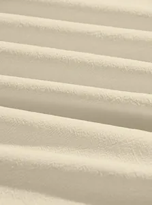 Macro detail of breathable cream-colored cotton linen fabric texture
