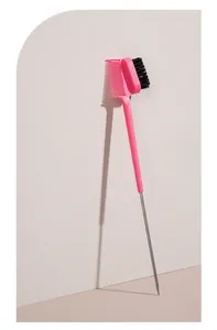 Double-headed pink eyebrow comb and eyelash brush tool featuring a sharp metal pin tail