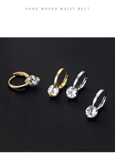 Macro detail view of sparkling cubic zirconia hoop earrings in gold and silver finishes