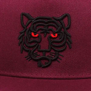 Close-up view of a maroon baseball cap featuring a detailed 3D tiger head embroidery design