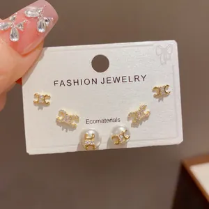 Elegant 3-piece gold-tone earring set featuring minimalist geometric and pearl designs