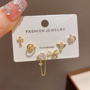 Close-up of a 6-piece gold-tone stud earring set with celestial and heart motifs.