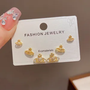 Three-piece set of elegant gold-plated Saturn orb stud earrings with crystal embellishments