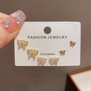 Close-up of stylish butterfly earring set with micro-pave crystals on white card