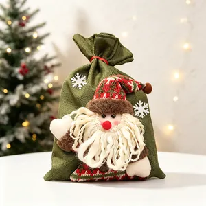 Sac cadeau de Noël festif en toile de jute verte avec poupée Père Noël 3D et flocons