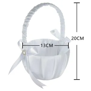 Detailed size view of a white satin flower girl basket with pearl and bow decor.