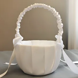 Elegant white satin flower girl basket with bow and pearl detail for wedding ceremony
