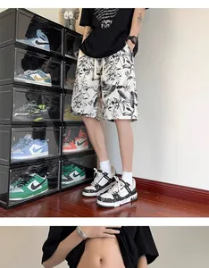 Detailed view of men's ink-style floral beach shorts with quick-dry fabric for summer.