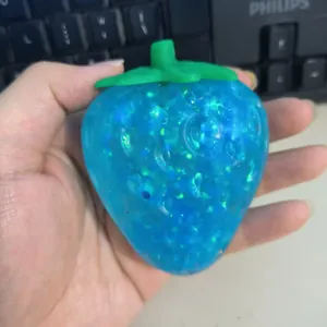 Blue glitter strawberry squishy toy for stress relief with slow rebound texture