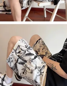 Detailed macro view of men's casual shorts featuring black and white ink-wash floral print