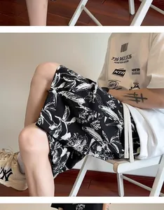 Close-up detail of men's casual shorts featuring black and white ink-wash floral print