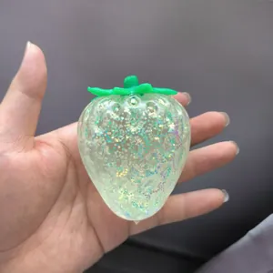 Close-up of a translucent strawberry squishy toy with glitter filling for stress relief
