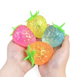 Set of four colorful strawberry squishy stress relief toys with sparkling glitter