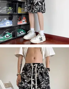 Detailed view of men's quick-dry shorts featuring a black and white ink floral print.