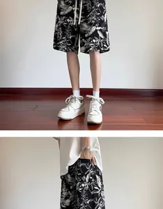 Detailed view of men's quick-dry shorts featuring a monochrome ink wash floral pattern