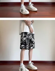 Detailed view of men's quick-dry shorts with black and white ink print.