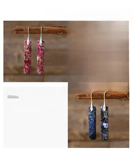Detailed view of bohemian rectangular natural stone earrings in pink and blue marble