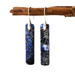 Bohemian style natural stone rectangular drop earrings with gold hooks on a branch.