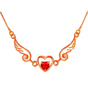 Close-up detail of rose gold angel wings necklace featuring a sparkling red heart gemstone