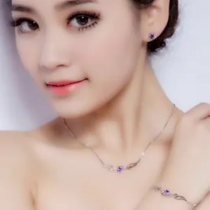 Silver angel wings heart jewelry set with purple gemstones worn by model