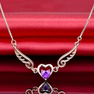 Close-up of rose gold necklace with purple heart stone and angel wings design