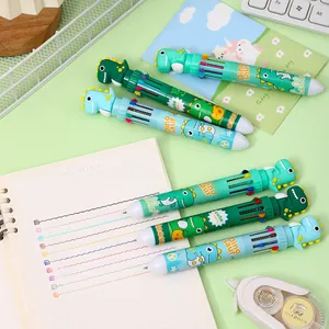 Close-up of colorful cartoon dinosaur 10-color ballpoint pens on a notebook