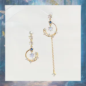 Elegant asymmetric star moon tassel earrings with gold finish and sparkling zircons