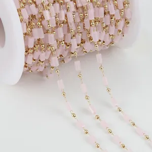 Macro detail of 14K gold filled jewelry chain with pink crystal cylinder beads DIY