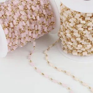 Detailed view of 14K gold-filled chains with pink and cream crystal rectangular beads.