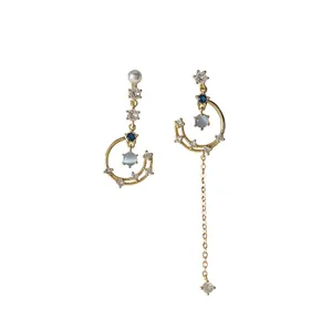 Elegant asymmetrical star moon tassel earrings with gold finish and sparkling zircons
