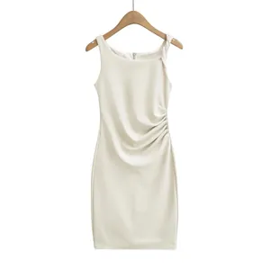 Detailed view of cream sleeveless dress featuring ruched side and slim fit design