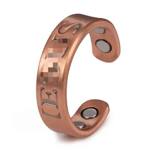 Detailed macro view of vintage brushed copper magnetic ring with engraved letters