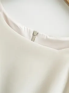 Close-up detail of the back zipper and textured fabric of an elegant sleeveless dress