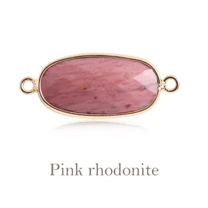 Detailed view of natural oval pink rhodonite stone jewelry connector with gold loops